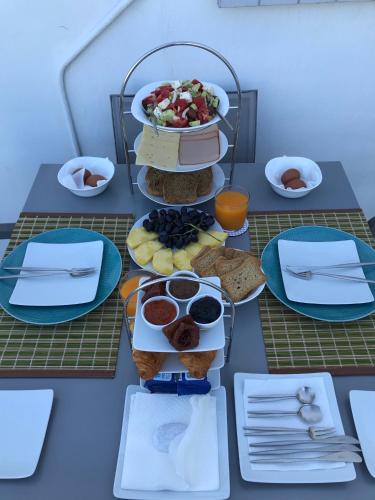 a table with plates of food on top at Melangel in Mýkonos City