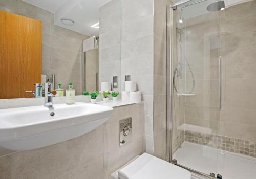 a bathroom with a sink and a shower at Southern View By My Getaways in Brighton & Hove