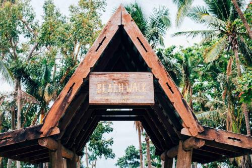 a sign in the shape of a building with palm trees at Airlie Sun & Sand Accommodation #2 in Airlie Beach