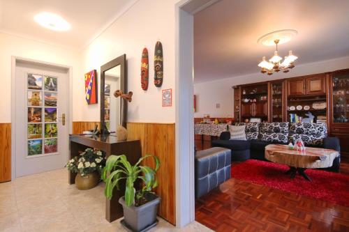 a living room with a couch and a table at Casa da Flor in Ribeira Grande