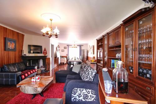 a living room with a couch and a table at Casa da Flor in Ribeira Grande