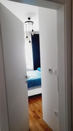 a bedroom with a bed in a room with a door at Skyline apartment in Bijeljina