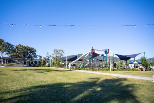 a playground with a slide in a park at Airlie Sun & Sand Accommodation #2 in Airlie Beach