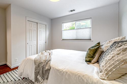 a bedroom with a bed and a window at Hedge Rose House in McKinleyville