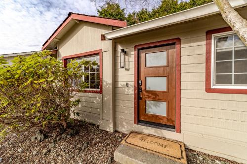 a small house with a brown door on it at Hedge Rose House in McKinleyville