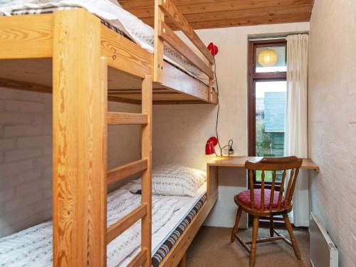 een slaapkamer met een stapelbed, een bureau en een stoel bij Holiday home Børkop III in Børkop