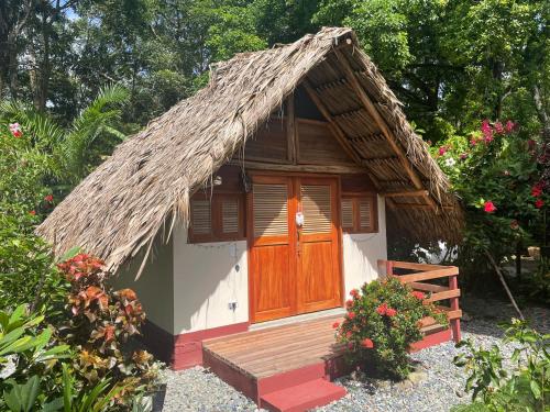 
a small wooden house with a wooden roof at Cabañas Tucan RNT 52523 in Capurganá
