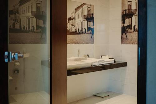 a bathroom with a sink and a mirror at Hotel Alter in Lublin