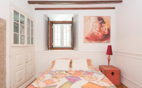 a bedroom with a bed and a window at River apartment center downton in Lisbon