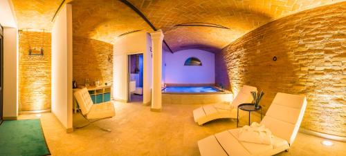 a room with a bed in a brick wall at Casa delle Noci country house, pool & SPA in Modena