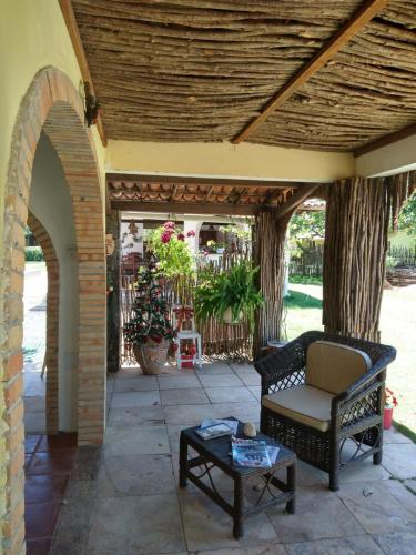 an outdoor patio with a chair and a table at Arco Mundial Taíba in Taíba