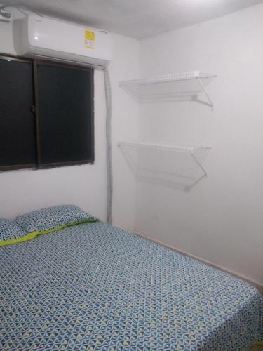 a small bedroom with a bed and a window at Encantadora casa con ambiente guajiro 2 in Barranquilla