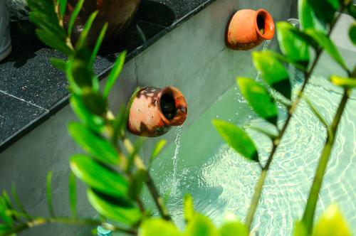 a fire hydrant with water coming out of it at Chi Homestay #4 in Hue