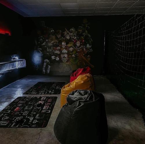 a dark room with a football mural on the wall at Hideout Farmhouse - By Seven Elements in Ras al Khaimah