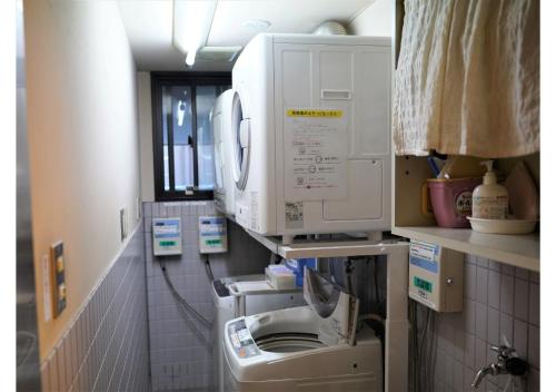 a laundry room with a washing machine and a dryer at Hotel Hachiman in Hachiman