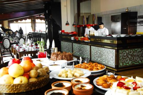 a table with many plates of food in a restaurant at Hotel Monec in Ankara