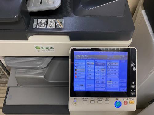a tablet computer sitting in front of an empty printer at Oita Regal Hotel in Oita
