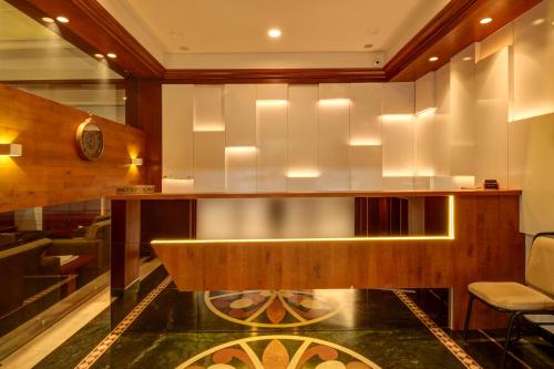 a lobby with a reception desk and a chair at SRTC Hotel Aspire in Ahmedabad