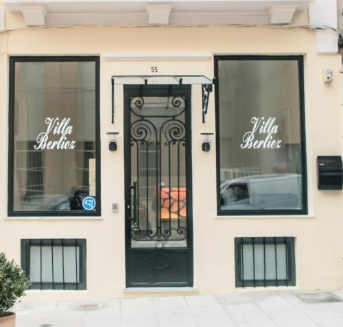 a store front with a black door and windows at Villa Berlioz in Nice