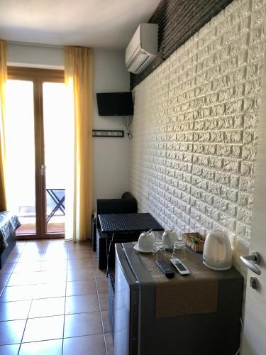 a kitchen with a stove and a brick wall at Affittacamere Alle 5 Terre in Monterosso al Mare