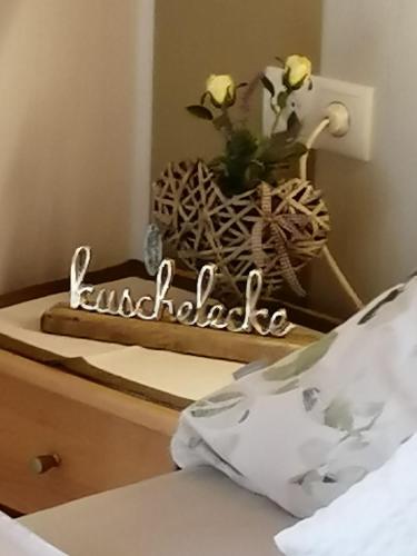 a bedroom with a table with a vase of flowers at Eifelferienwohnungen "Familie Saxler" in Bereborn
