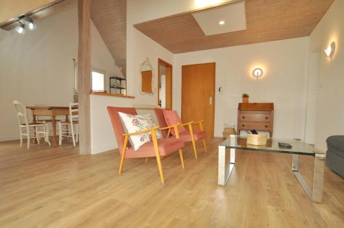 a living room with a couch and a table at L'Hirondelle - Charming flat - in Blotzheim