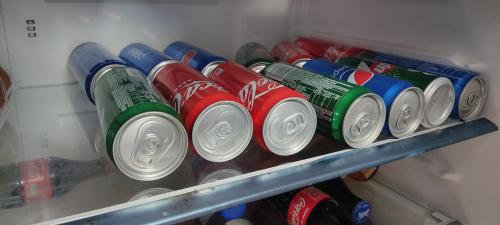 a row of cans of soda in a refrigerator at Bukit Rimau Instagrammable 2 Bedroom Apartment With Pool View up to 5 PAX in Shah Alam