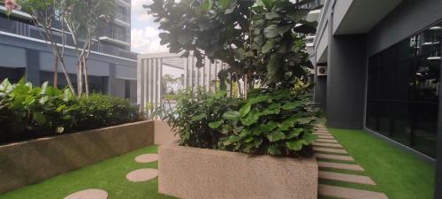 a courtyard with plants in a building at Bukit Rimau Instagrammable 2 Bedroom Apartment With Pool View up to 5 PAX in Shah Alam