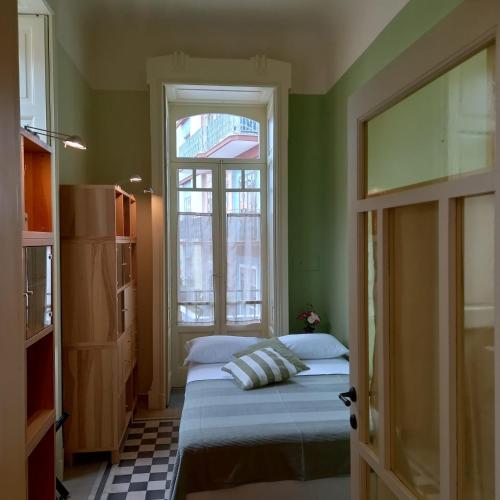 a small bedroom with a bed and a window at La Dimora del Porto in Bisceglie