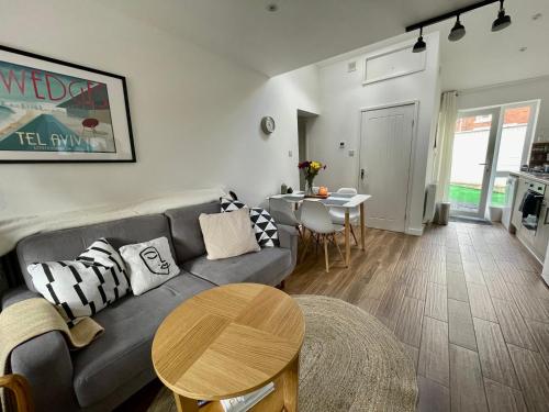 a living room with a couch and a table at The Corner House - Modern Chesterfield Town Centre Apartments in Chesterfield