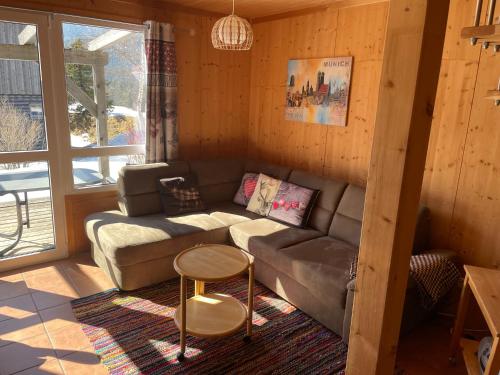 a living room with a couch and a table at Feriendorf Tauerngast in Hohentauern