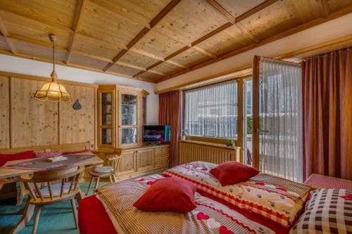 a bedroom with two beds and a table in it at Apartments Olympiastraße in Seefeld in Tirol