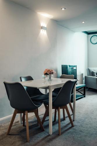 a table and chairs in a living room at Apartments-DealHouse in Huddersfield