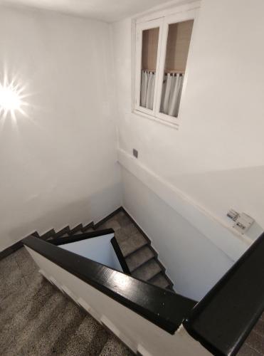 a room with a staircase with a window at Apt VILLA CUDILLERO in Cudillero