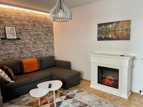 sala de estar con sofá y chimenea en Polar apartment en Rovaniemi