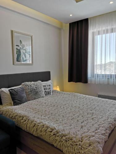 a bedroom with a large bed with a sign on it at Šilja Kopaonik S45 Milmari in Kopaonik