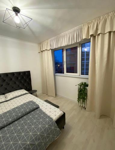 Ένα ή περισσότερα κρεβάτια σε δωμάτιο στο TALINA Apartament