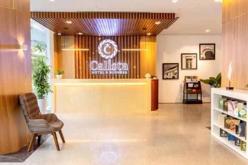 a lobby of a salon with a chair and a counter at Calista Sai Gon Hotel in Ho Chi Minh City