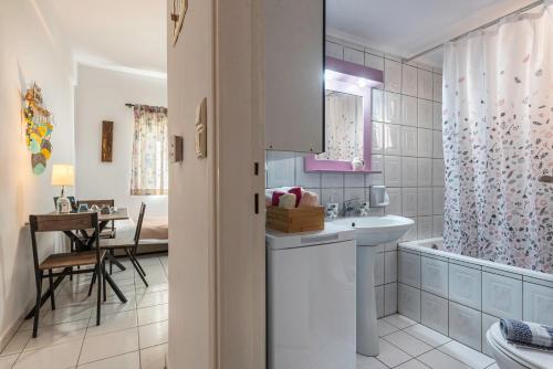 a bathroom with a sink and a toilet and a tub at Blossom in Ierapetra