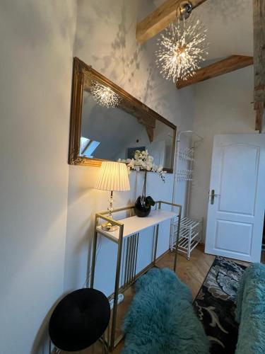 a room with a mirror and a table with a lamp at Comfort Zone Ostróda Villa Apartment Duplex in Ostróda
