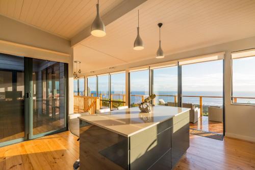 a kitchen with a view of the ocean at Constantia Views Villa Wilderness in Wilderness