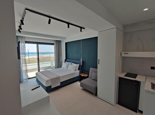 a bedroom with a bed and a view of the ocean at Onar in Sarti in Sarti