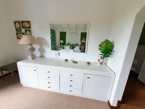 a bathroom with a white dresser with a mirror at Villa at Selborne Golf Estate in Pennington