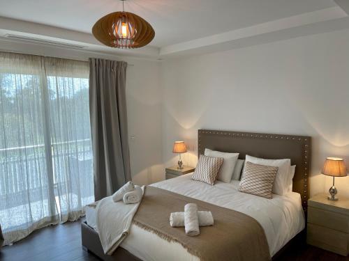 a bedroom with a large bed with two towels on it at PUERTO BANUS Apartamento FANTASTICO in Marbella