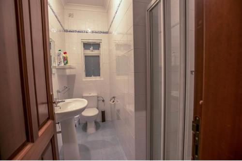 a bathroom with a shower and a toilet and a sink at Bugibba Square Seaview 3 Bedroom Apartment in St. Paul's Bay