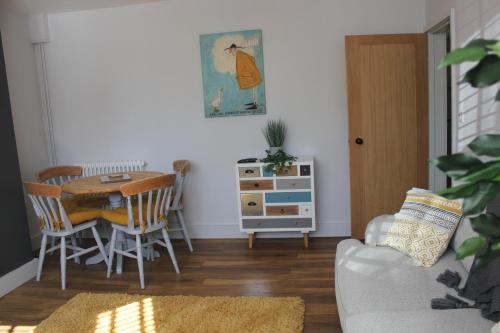 a living room with a table and a chair at 1-Bed Apartment in Wells in Wells