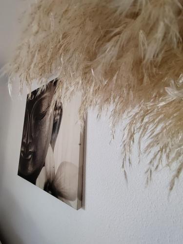 a picture of a mask with feathers on a wall at wonderful penthouse with view playa las vistas in Arona