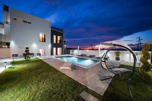 a backyard with a swimming pool and a house at D-Palace-Lux in Donji Zemunik