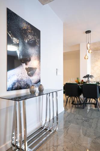 a table in a room with a picture on the wall at D-Palace-Lux in Donji Zemunik