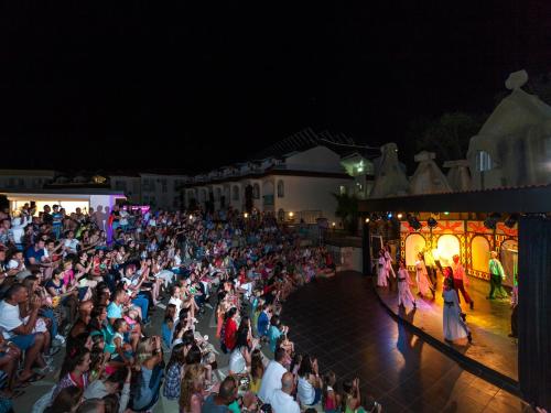 Una gran multitud de personas viendo un espectáculo por la noche en Lykia Botanika Beach Fun & Club - All Inclusive, en Fethiye
